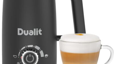 Dualit Milk Frother Max in black with a glass of frothed latte beside it