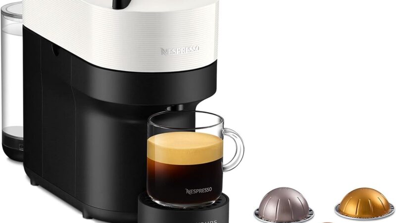 Nespresso Vertuo Pop pod coffee machine by Krups in Coconut White with a mug of coffee
