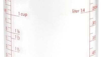 OXO Good Grips adjustable measuring cup, a clear cylinder with red cup and millilitre markings and a black base