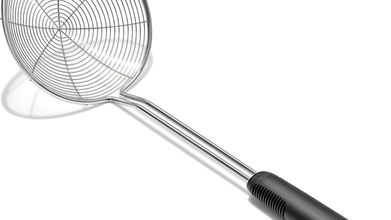 OXO Good Grips spider strainer, a round stainless steel wire-coil basket on a long handle with a black grip