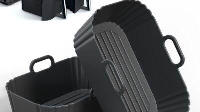 Two black PINTAUR silicone air fryer liners with handles, shown beside a Ninja dual basket air fryer