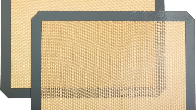 Two Amazon Basics silicone baking mats in beige with grey borders