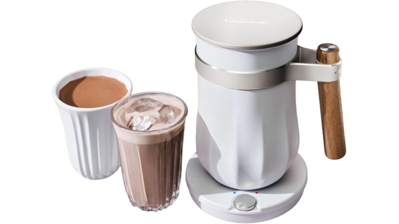 Hotel Chocolat Velvetiser hot chocolate machine in Chalk with a ceramic Podcup and a Podglass of iced chocolate
