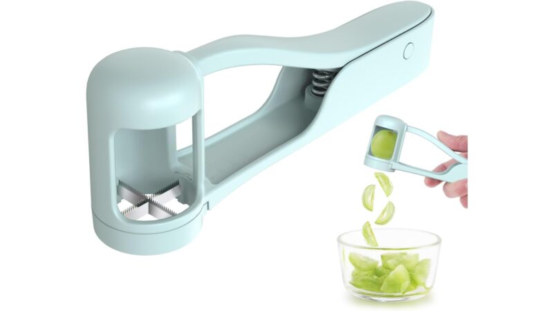 Luvan grape cutter with a cup and cross-shaped stainless steel blade, cutting a grape into quarters into a bowl