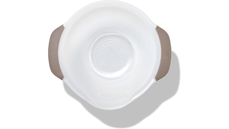 OXO Good Grips rice and grains washing colander, a white bowl with small drain holes, a pour spout and grey handles