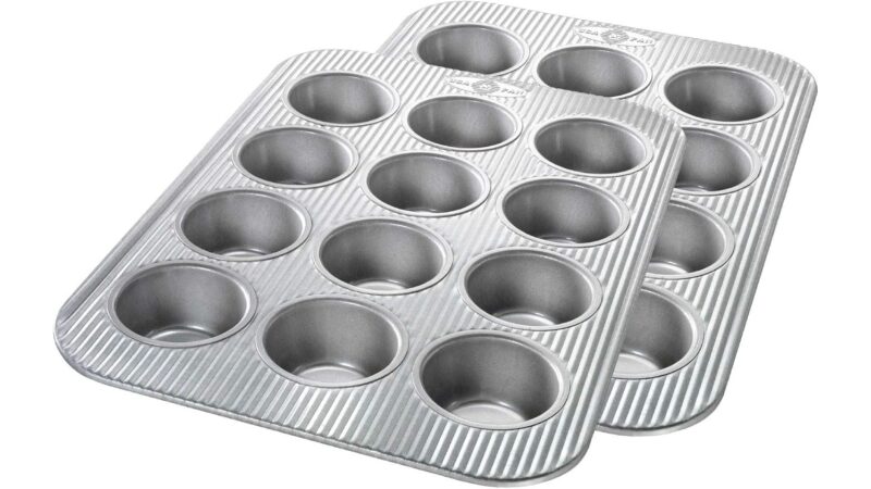 Two USA Pan 12-well aluminised steel muffin pans with a ridged surface